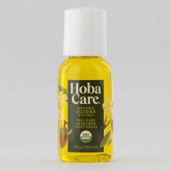ORG HobaCare 1oz square 1 ounce clear bottle filled with golden organic jojoba on a gray background