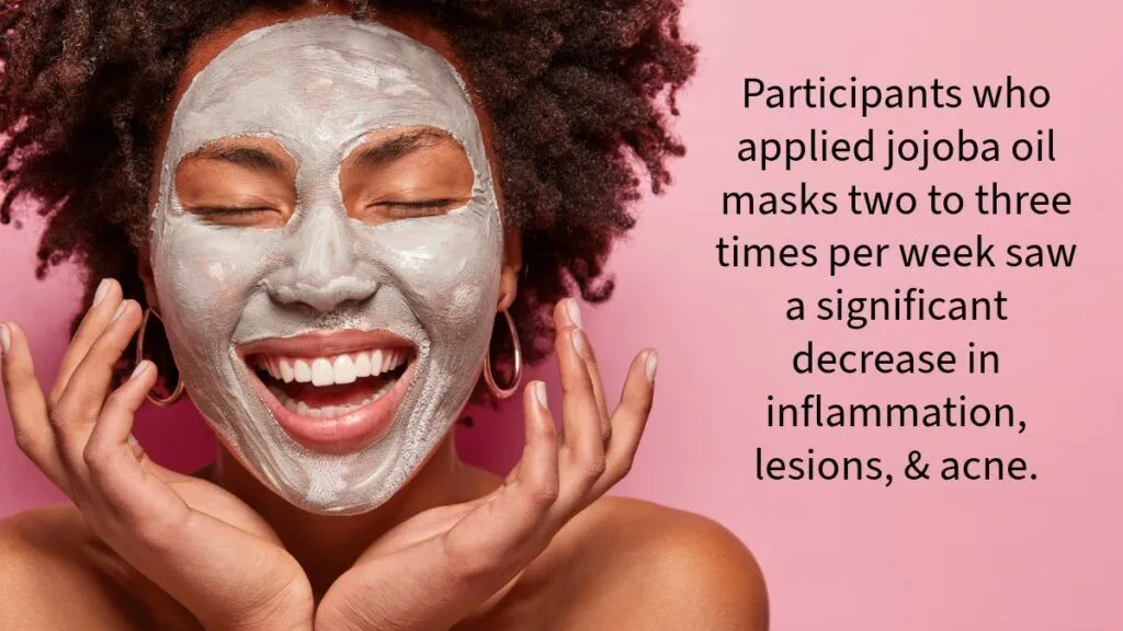 smiling dark skinned woman with a drying mask of clay and jojoba oil for acne covering her face 