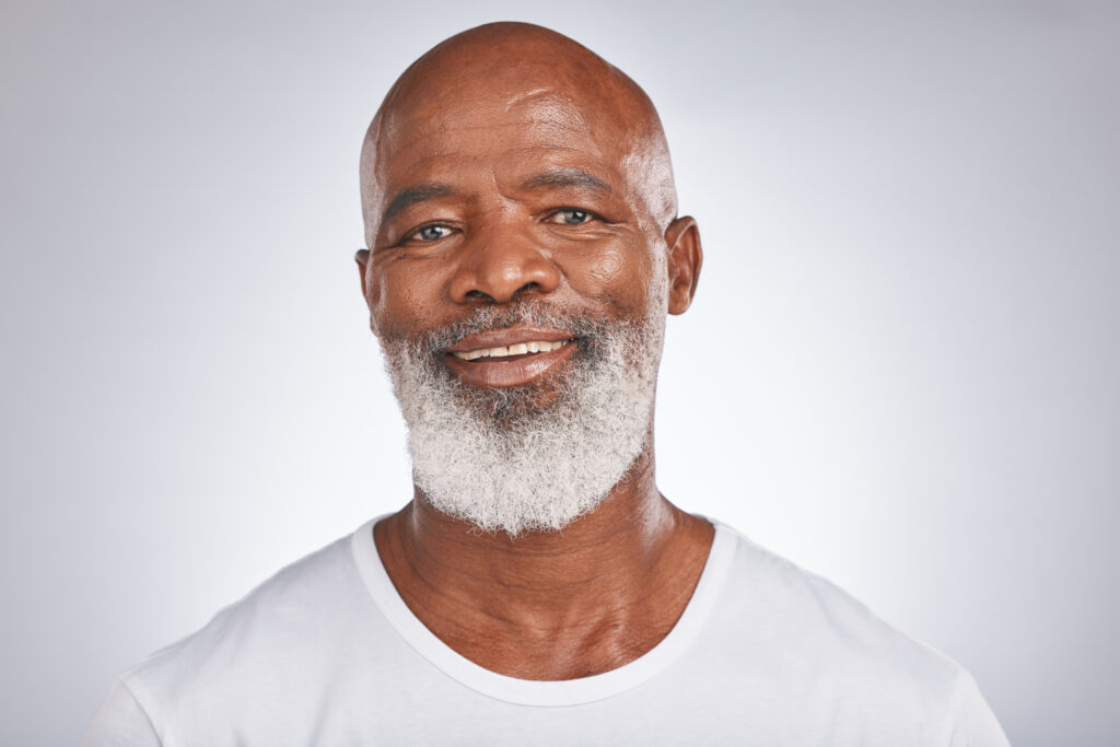 older African American male with gray beard to showcase jojoba is the best beard oil

