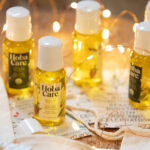 sharing size bottle of golden jojoba surrounded by fairy lights