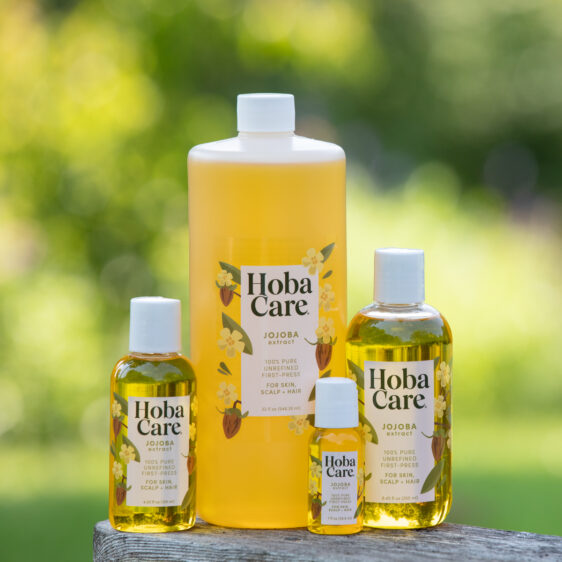 Various sizes of HobaCare Jojoba outdoors with blurry green background