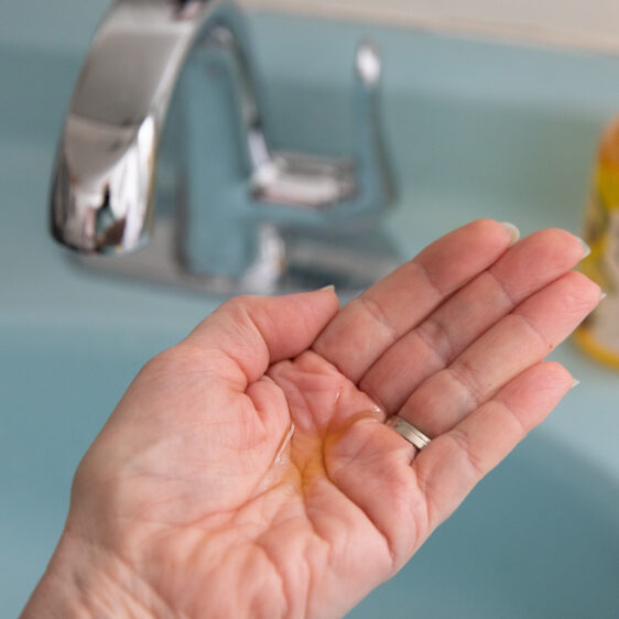 hand with jojoba oil in palm before oil cleansing