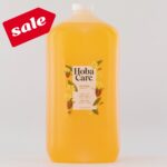 128 fl oz bottle of golden HobaCare Jojoba on light gray background