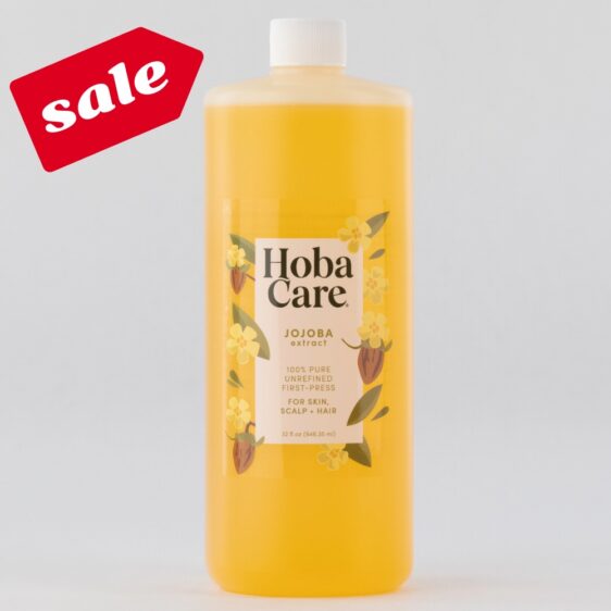 32 oz bottle of golden hobacare jojoba on a light gray background