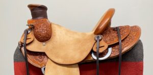 two tone brown leather saddle with intricate flower pattern carved into the leather that has been protected and enhanced with natural jojoba oil